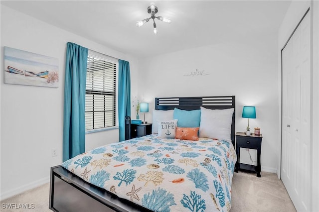 bedroom with light colored carpet and a closet