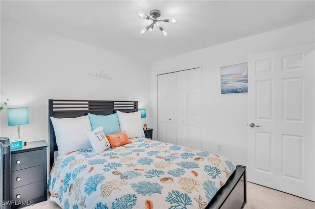 bedroom with light colored carpet and a closet