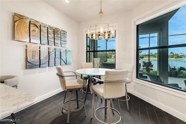 dining room with a chandelier and a water view