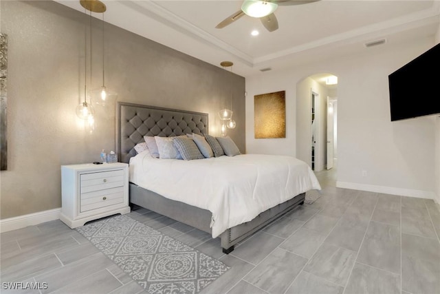 bedroom featuring ceiling fan and a tray ceiling