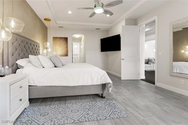 bedroom with ceiling fan and a raised ceiling