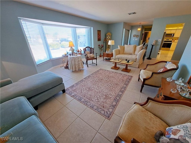 living room with light tile patterned floors and visible vents