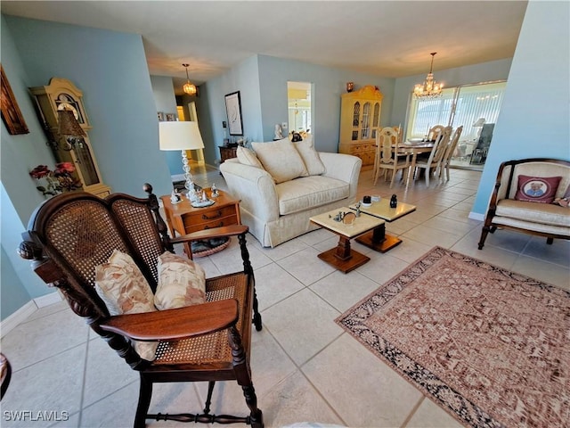 living room featuring light tile patterned flooring, a notable chandelier, and baseboards