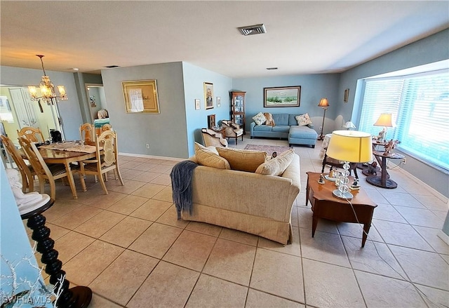 living area featuring light tile patterned floors, baseboards, visible vents, and a notable chandelier