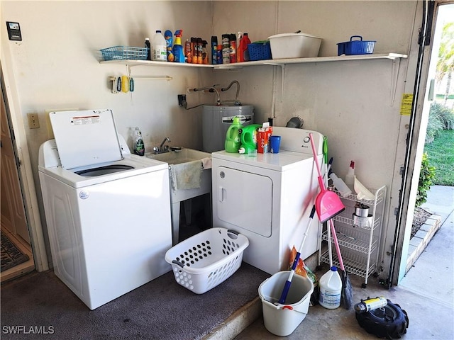 washroom with water heater, laundry area, and independent washer and dryer