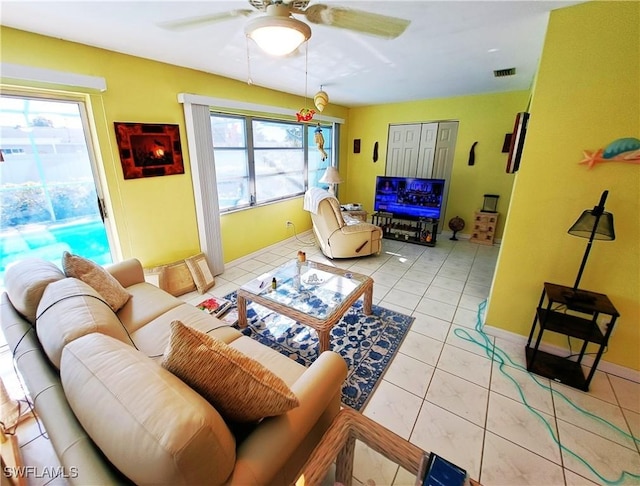 1727 Lakeview Blvd, North Fort Myers, FL 33903 - living room featuring ceiling fan, healthy amount of natural light, light tile patterned flooring, and baseboards