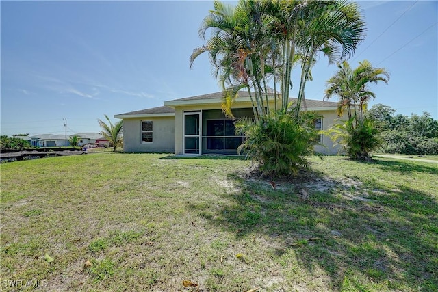 rear view of house with a yard