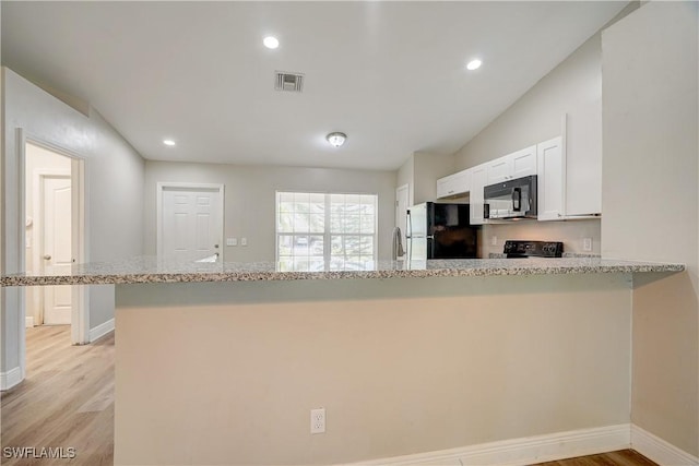 kitchen with kitchen peninsula, white cabinetry, light stone countertops, and black appliances