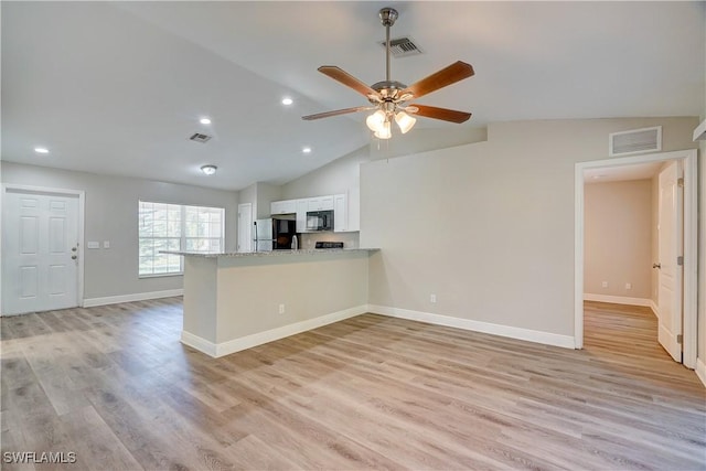 kitchen featuring black appliances, white cabinets, light hardwood / wood-style floors, light stone counters, and kitchen peninsula