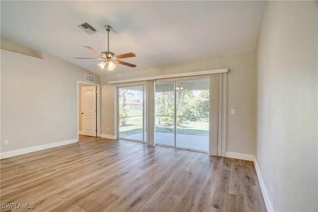 spare room with light hardwood / wood-style floors, ceiling fan, and lofted ceiling