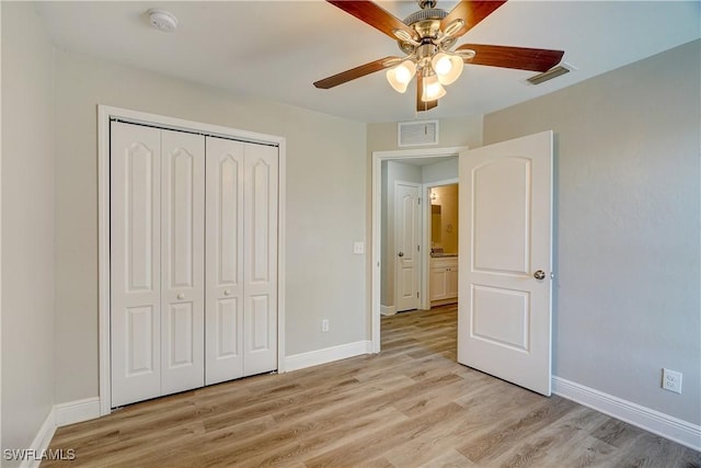 unfurnished bedroom with ceiling fan, light hardwood / wood-style flooring, and a closet