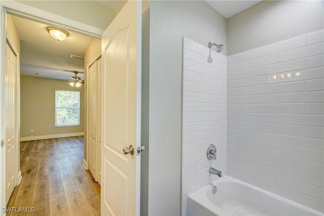 bathroom featuring hardwood / wood-style floors, tiled shower / bath, and ceiling fan