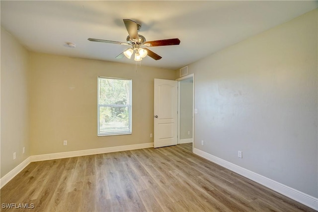 empty room with ceiling fan and light hardwood / wood-style floors