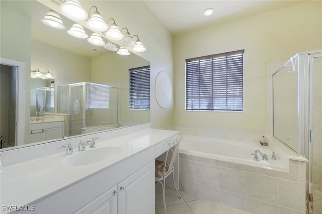 bathroom featuring tile patterned flooring, vanity, a notable chandelier, and separate shower and tub