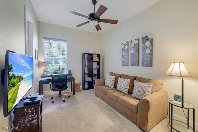 carpeted office space with ceiling fan