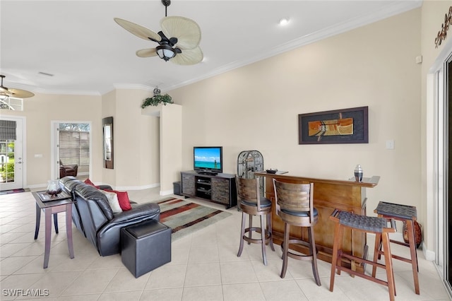 tiled living room featuring ceiling fan, indoor bar, and ornamental molding