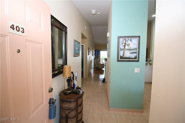 hall featuring light tile patterned floors