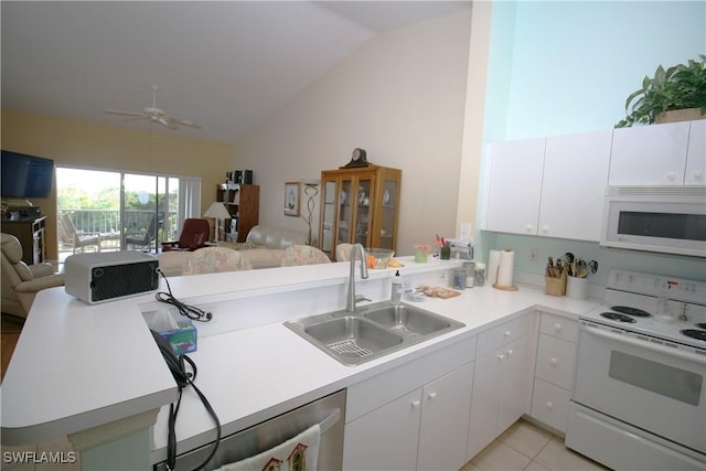 kitchen featuring white appliances, white cabinets, sink, light tile patterned floors, and kitchen peninsula