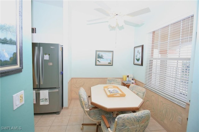 tiled dining space with ceiling fan