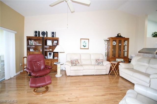 living room with ceiling fan, light wood-type flooring, and lofted ceiling