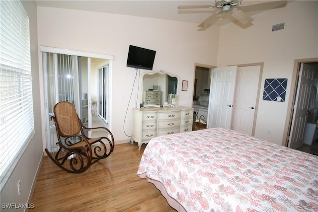 bedroom featuring connected bathroom, ceiling fan, light hardwood / wood-style flooring, and vaulted ceiling