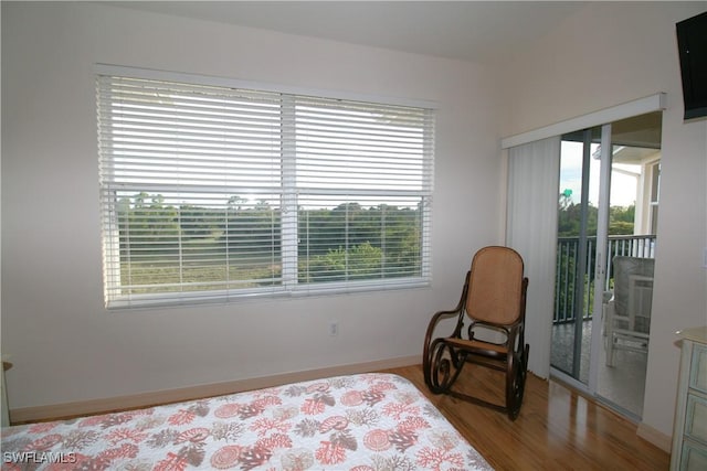 bedroom featuring light hardwood / wood-style floors and access to outside