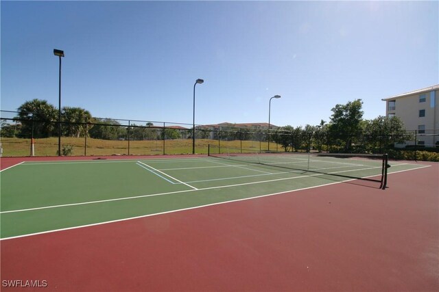 view of tennis court featuring basketball court