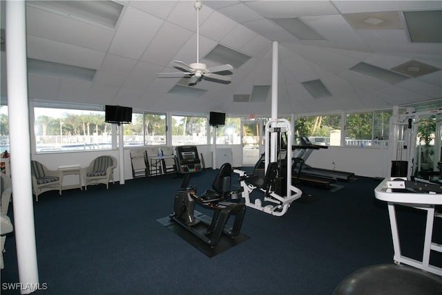 gym featuring ceiling fan and lofted ceiling