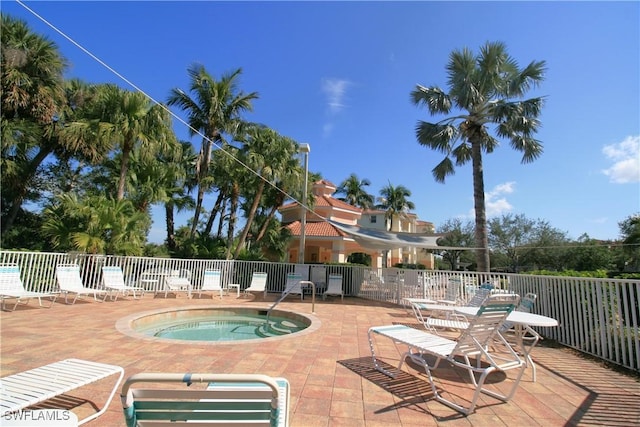 view of swimming pool with a community hot tub and a patio area