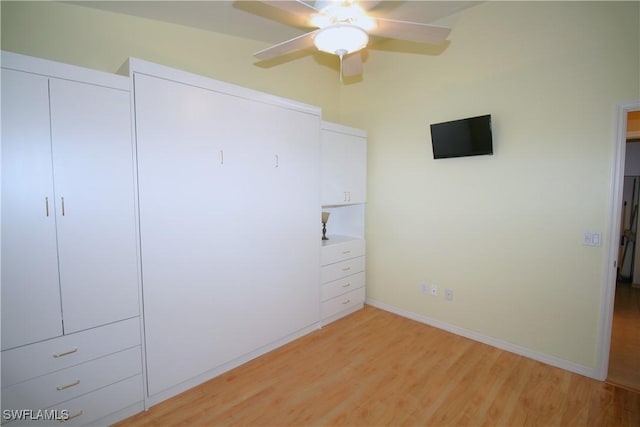 4009 Palm Tree Blvd Unit 403, Cape Coral, FL 33904 - unfurnished bedroom featuring a closet, baseboards, ceiling fan, and light wood-style floors