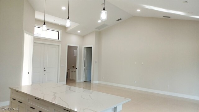 kitchen with light stone counters, decorative light fixtures, high vaulted ceiling, and white cabinets