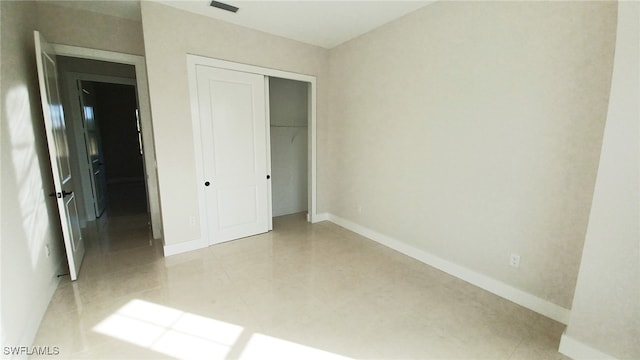 unfurnished bedroom featuring a closet, visible vents, and baseboards