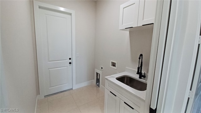 clothes washing area featuring sink, cabinets, light tile patterned floors, hookup for a washing machine, and electric dryer hookup