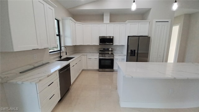 kitchen with stainless steel appliances, white cabinetry, sink, and pendant lighting