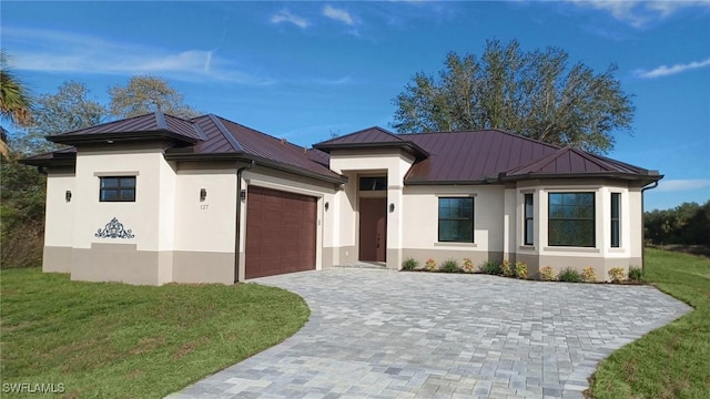 prairie-style home with a garage and a front yard