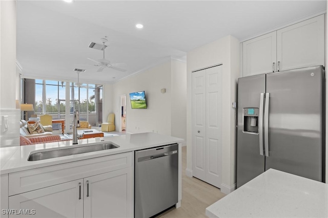 kitchen with ceiling fan, sink, white cabinets, and appliances with stainless steel finishes