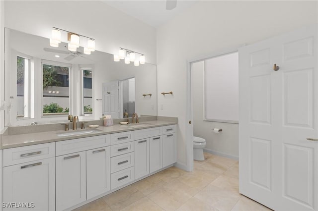 bathroom with ceiling fan, tile patterned flooring, vanity, and toilet