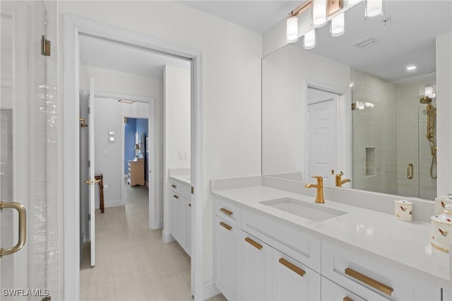 bathroom with vanity and a shower with door