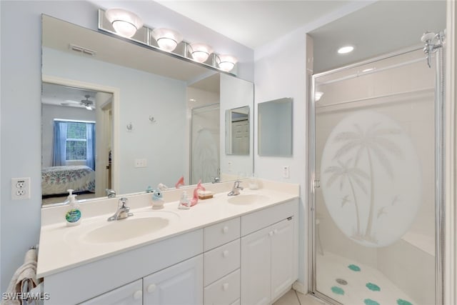 bathroom with an enclosed shower, vanity, and ceiling fan