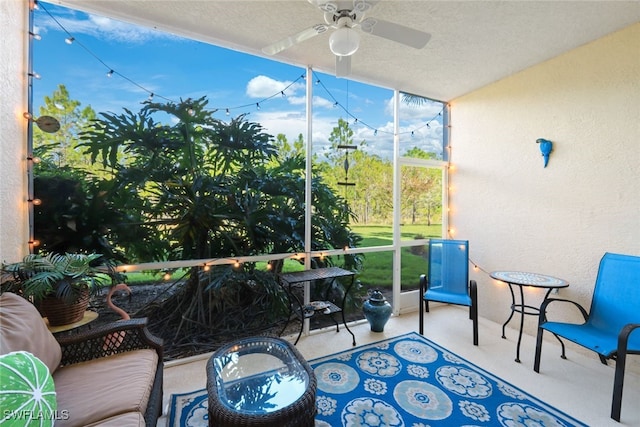 sunroom featuring ceiling fan