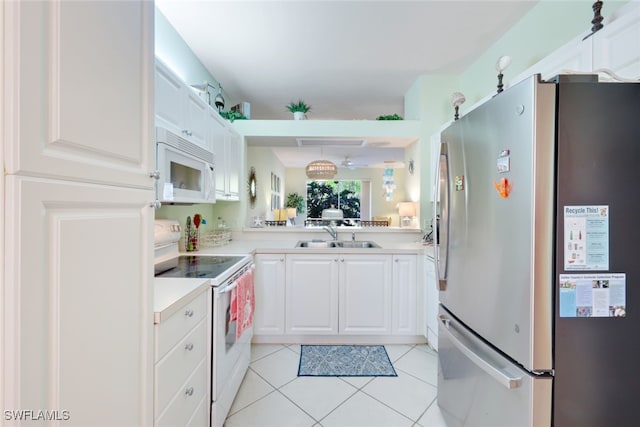 kitchen featuring white cabinets, white appliances, sink, and light tile patterned floors