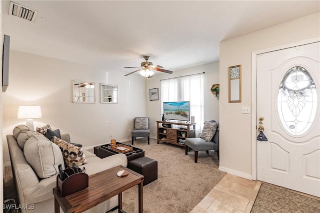 living room with ceiling fan and light tile patterned flooring