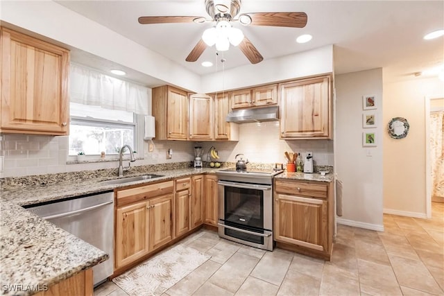 kitchen featuring ceiling fan, sink, stainless steel appliances, light stone counters, and backsplash