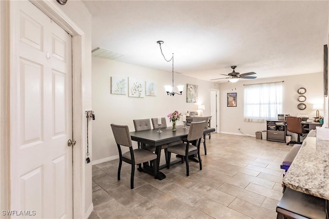 dining room with ceiling fan with notable chandelier