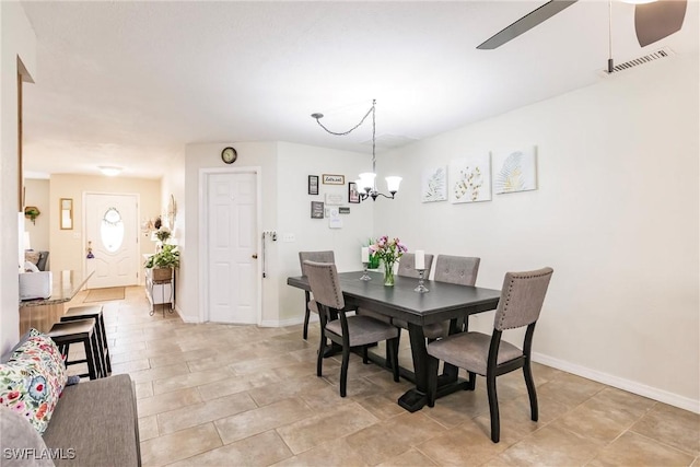 dining area featuring ceiling fan with notable chandelier