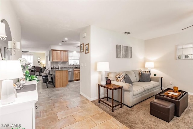 living room with plenty of natural light and light tile patterned floors