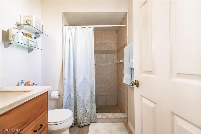 bathroom with tile patterned floors, vanity, toilet, and walk in shower