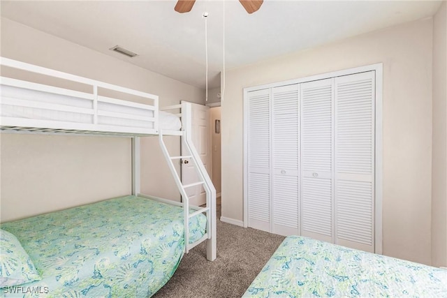 carpeted bedroom featuring ceiling fan and a closet