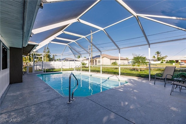 view of pool featuring glass enclosure and a patio area