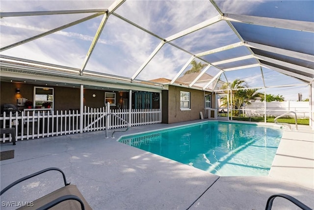 view of swimming pool featuring a patio area and a lanai